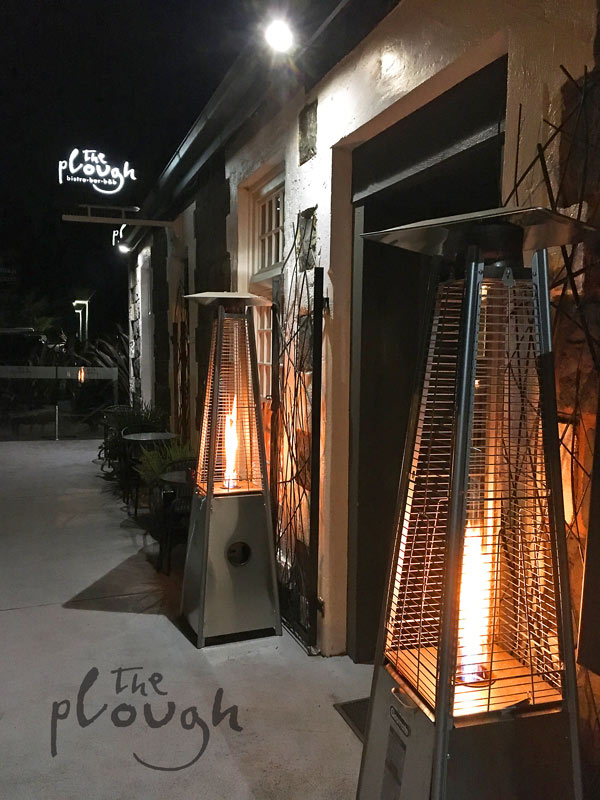 The Plough outside with warm gas heaters inviting you inside.